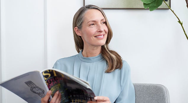 Female looks side with smile.